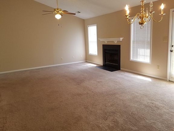Spacious living room with a cathedral ceiling and FP