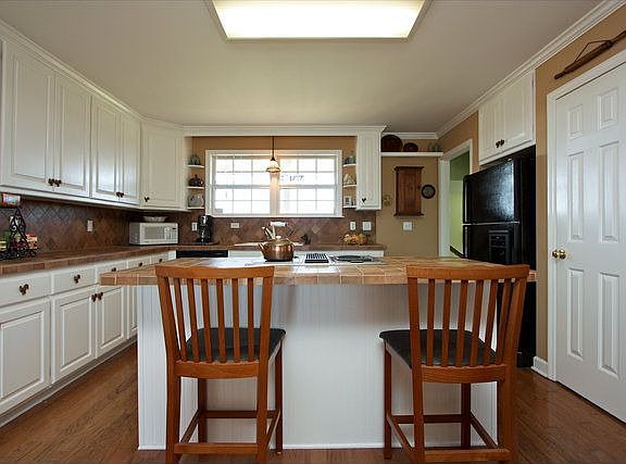 Updated kitchen with tile countertops, hardwood floors, renovated cabinets! 