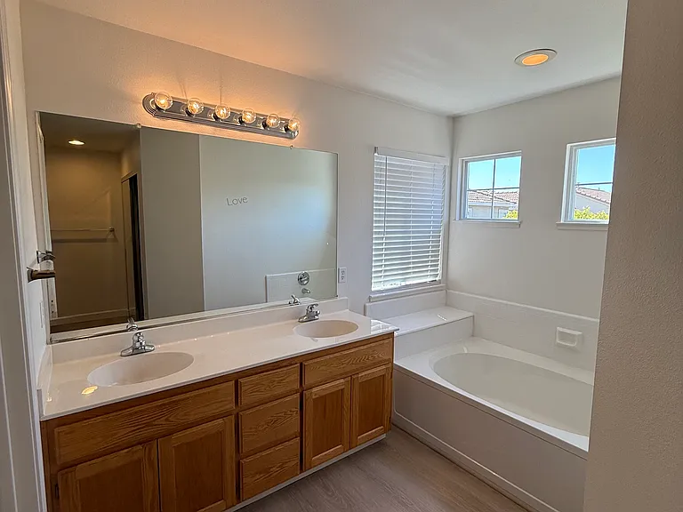 Master Bathroom with 2 sinks and bathtub.