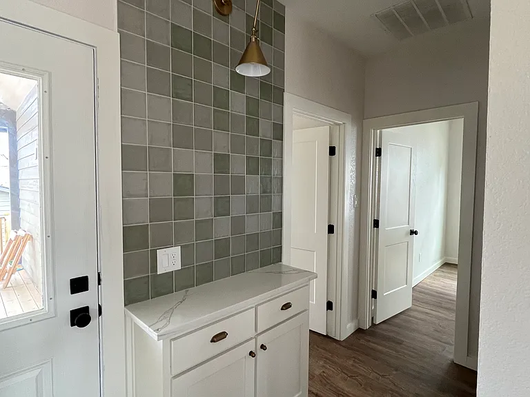 Coffee Bar, next to back patio, Primary Bedroom, Bedroom #2, and Laundry Room (across from bar)