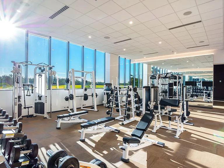 A fully equipped fitness center features strength training and cardio equipment.