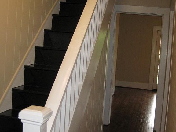 Stairs to attic with spacious storage.