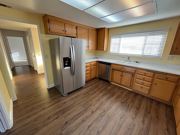 Kitchen with brand new dishwasher and refrigerator.