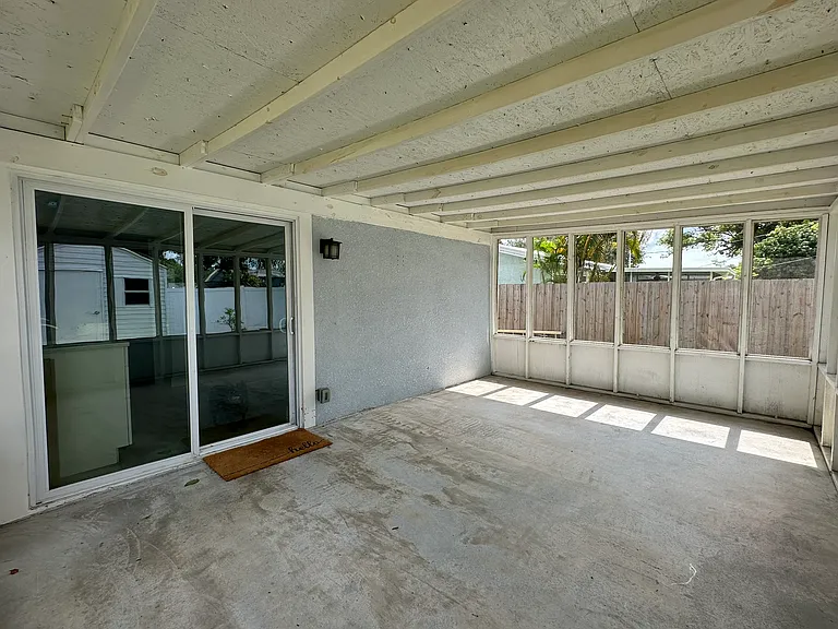 large screened in back porch; the wood was freshly painted after taking this photo
