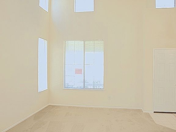 Living room boast 2-story high ceilings.