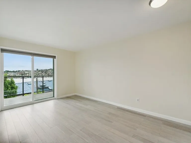 bedroom w/ wood floors & view
