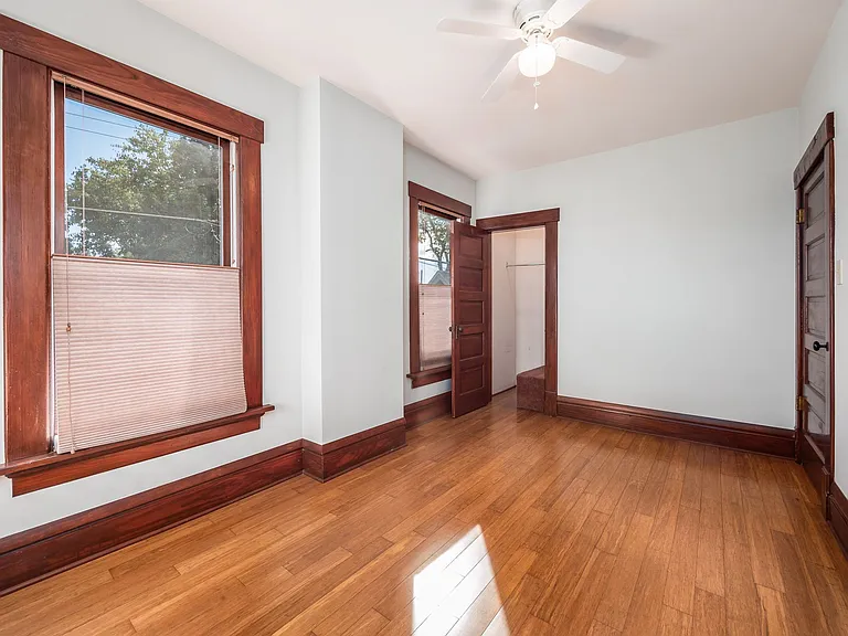 Bedroom 2 with good closet storage and south facing windows. Ceiling fan/lighting has been replaced since photos. Bamboo floors.