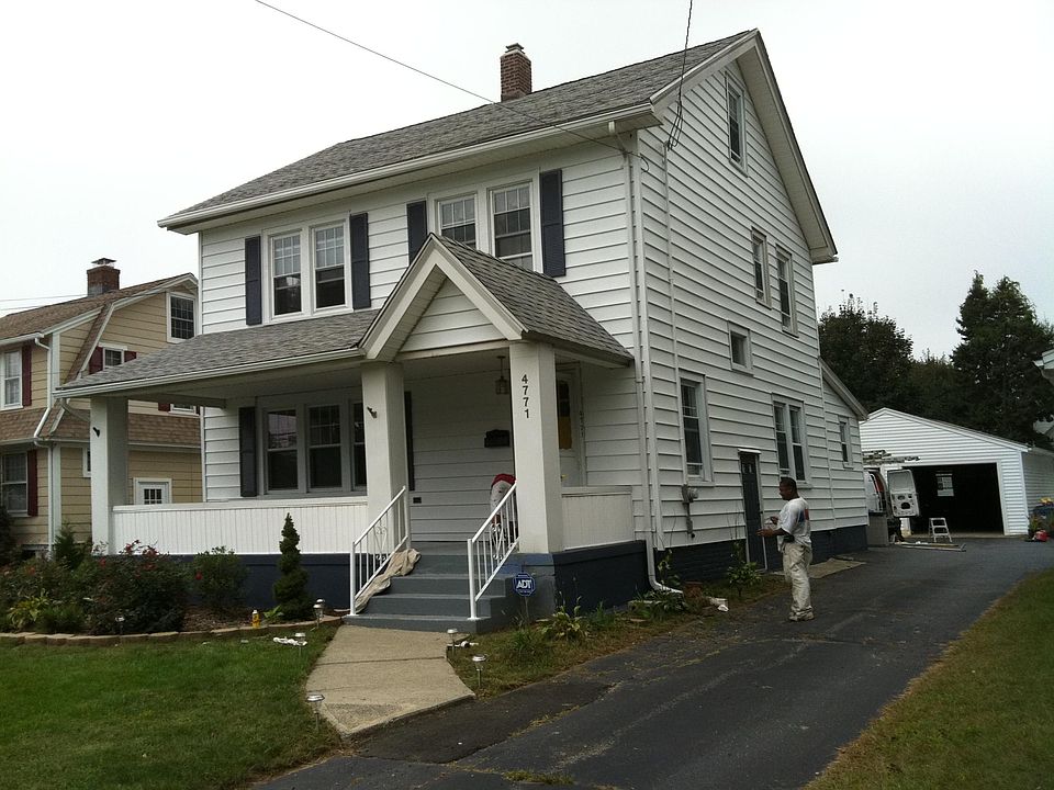 Front of house with front lawn, driveway to garage 