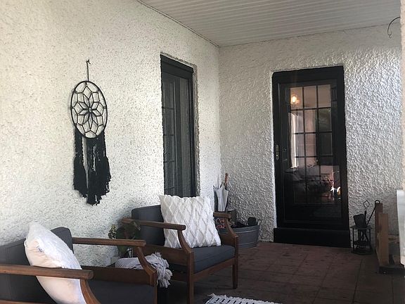 Screened-in front porch; trees provide privacy