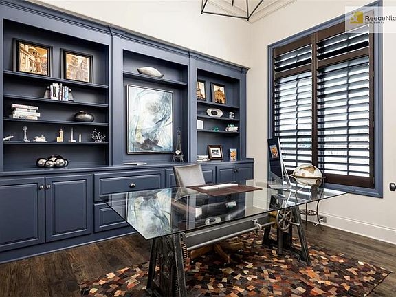 Main floor office w/ built in's, wood floors, vaulted ceilings and plantation shutters.