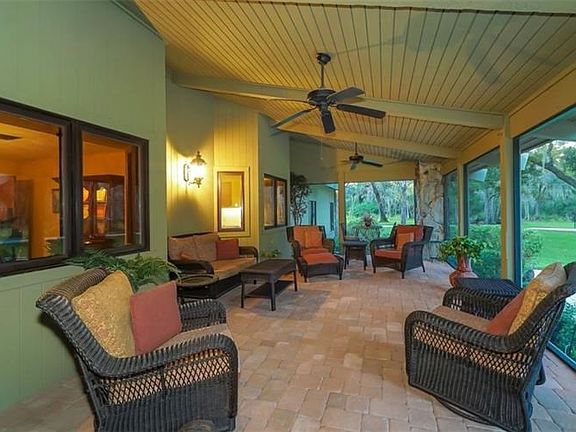 Enjoy relaxing on the screened front porch and enjoy the views beyond.