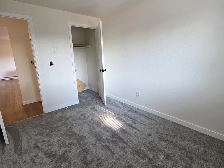 Another view of 3rd bedroom with new light fixture and walk in closet