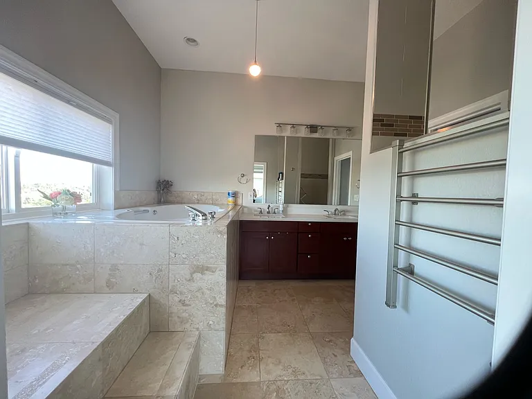 Master bath with sunken tub, heated towel rack, 2 sinks, and large shower. Separate toilet room.
