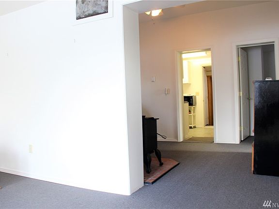 Looking from the L/R through an extra finished room into the kitchen and beyond into the utility room and back door.