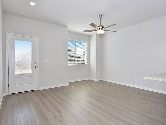 The family room is spacious with a ceiling fan.