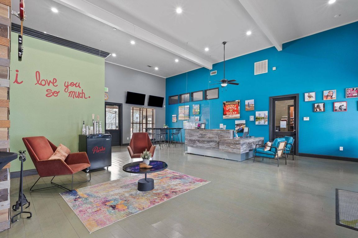 Stylish Community Lounge with Fireplace at Ovation Apartments in Austin, TX