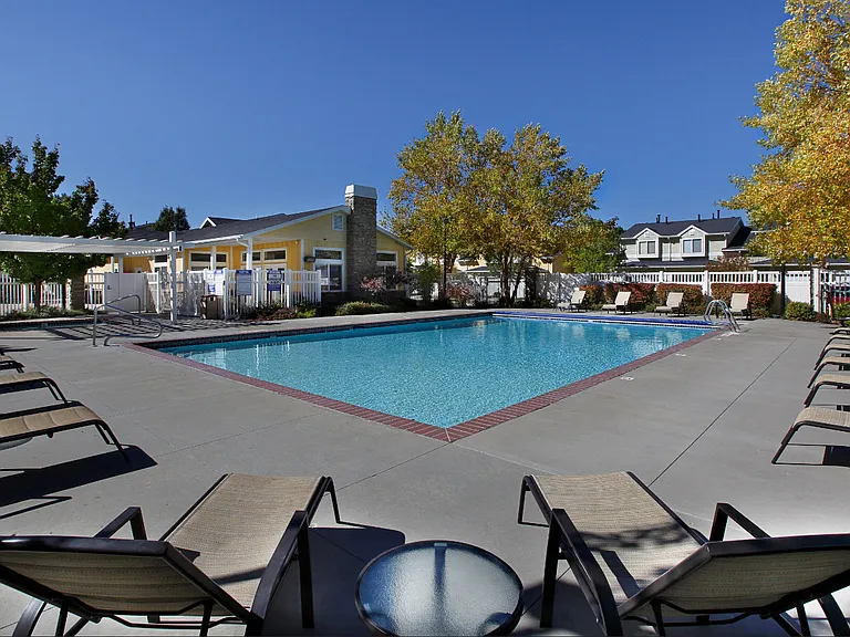 Liberty Hill Apartments, Draper, Utah, pool surrounded by chairs and trees.