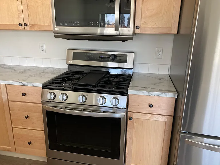 LG Gas stove and oven with Air Fry capabilities. Convenient microwave oven.