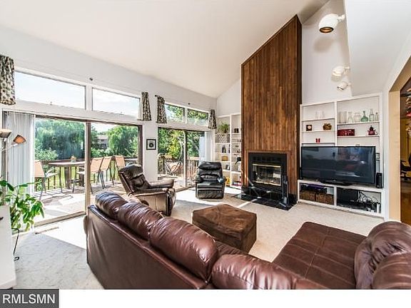 Family room with fireplace, vaulted ceilings and great lighting overlooking the private back yard.