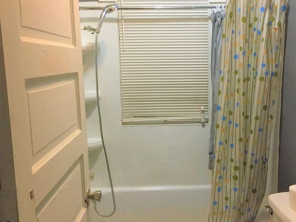 Bathroom with new toilet, vanity, and shower fixtures