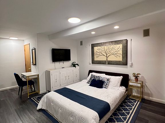 Queen size bed, dresser, and working desk.