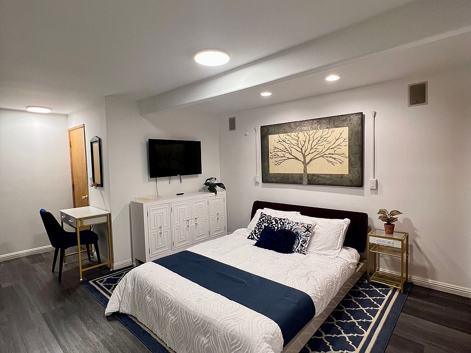 Queen size bed, dresser, and working desk.