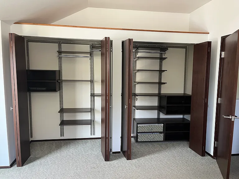 Custom organization added to primary bedroom closet.