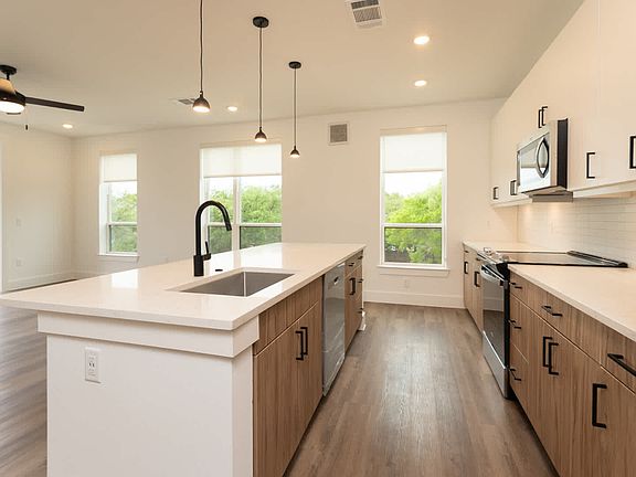 Kitchen with island and hard surface flooring