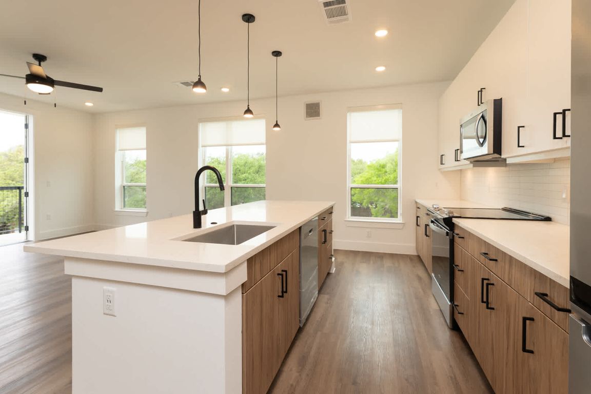 Kitchen with island and hard surface flooring
