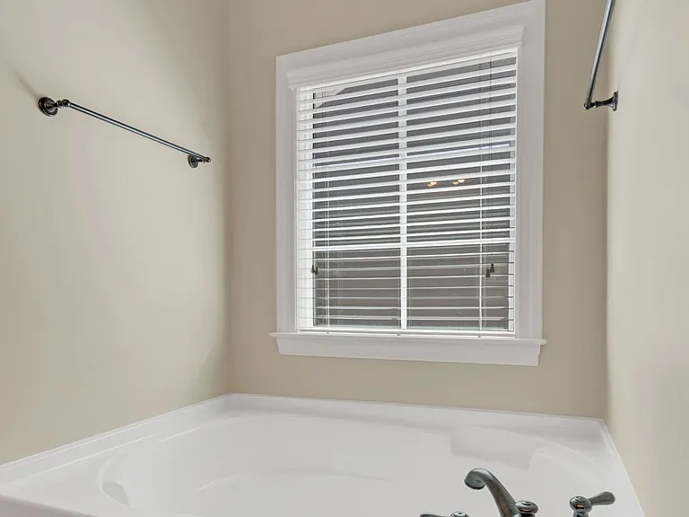 The master bath has a large soaking tub and large window allowing natural light