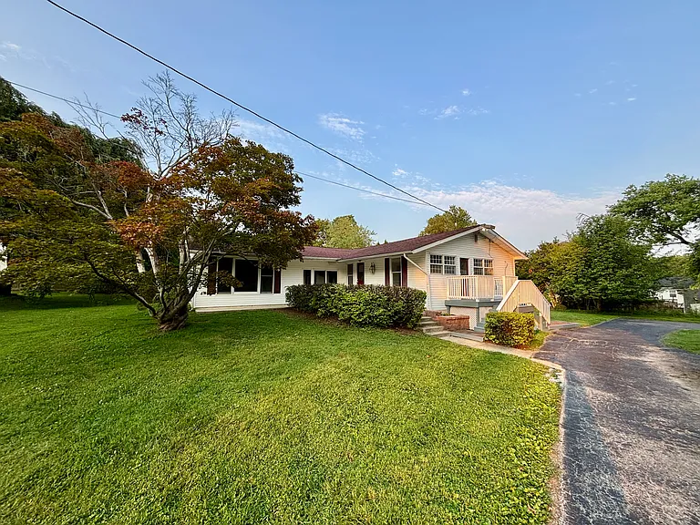 Welcome home to this beautifully maintained ranch situated on nearly an acre, featuring a long private driveway, inviting front porch, mature landscaping, and exceptional curb appeal.