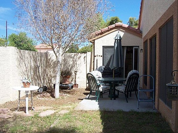 Party on the Patio!! The yard also wraps around the back of the home.
