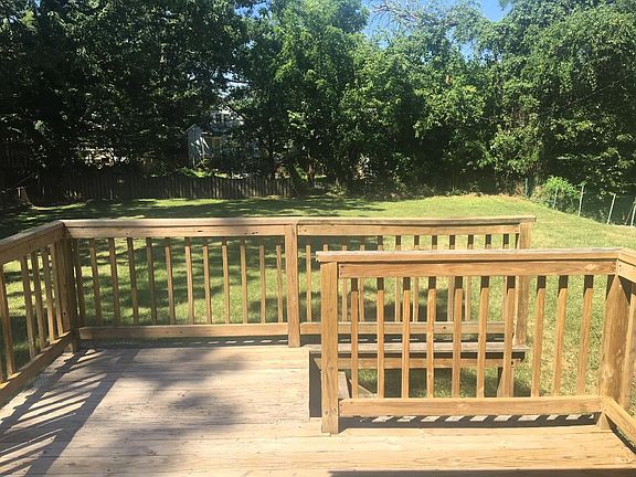 Porch overlooking large, fenced backyard