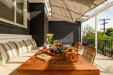 Inviting patio with a stylish outdoor dining area and comfortable seating, perfect for alfresco meals, morning coffee, or relaxing evenings.