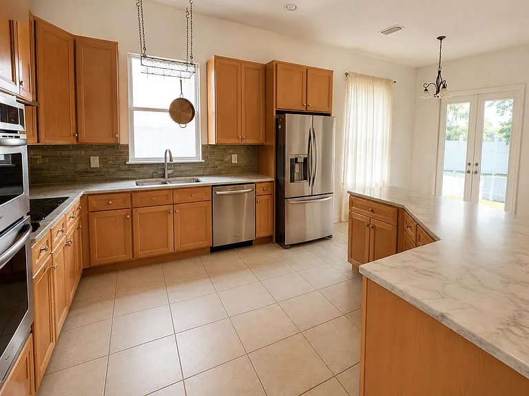 Upgraded appliances with QUARTZ countertop. Large sink. Electric stovetop. Stacked Oven and Microwave.