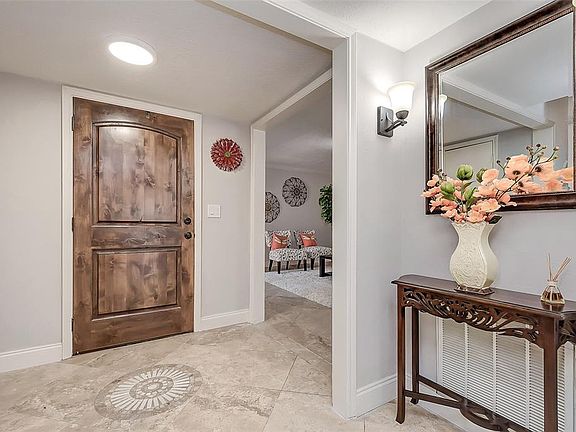 A view of the front entry with beautiful travertine floors throughout the first level.