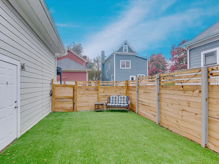 Turf yard accessed by living room and garage