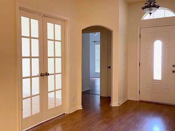 Great Room / Living Room showing front door, french doors to bedroom 2 / office space, front hallway