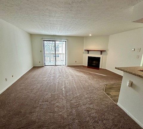 Another view of living room- sliding glass door to the balcony