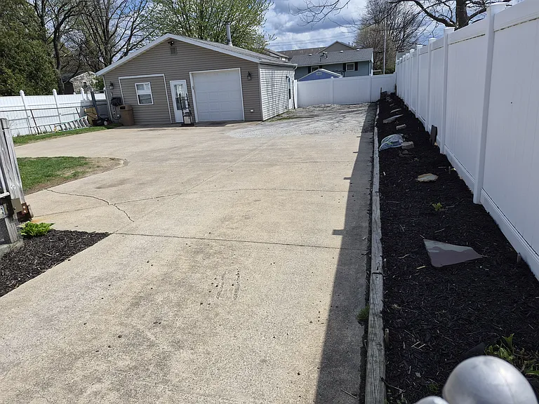 Off street parking area & place for flowers next to the fence