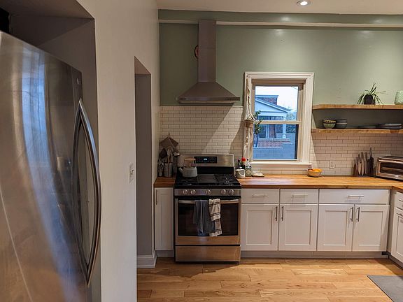 Newly renovated kitchen. Hardwood floor, custom shelves, new appliances, butcherblock countertop.