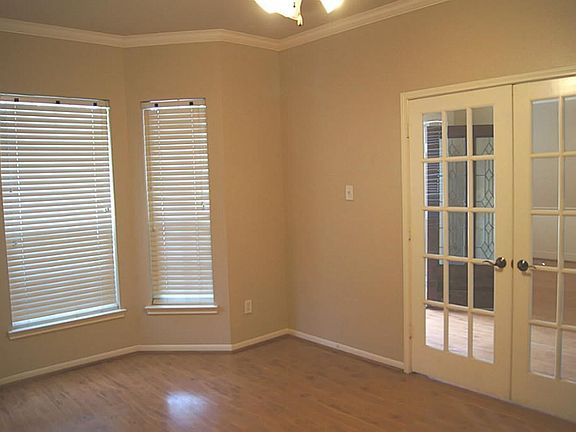 Study with  French doors. Crown molding and base board. Three windows for natural light.