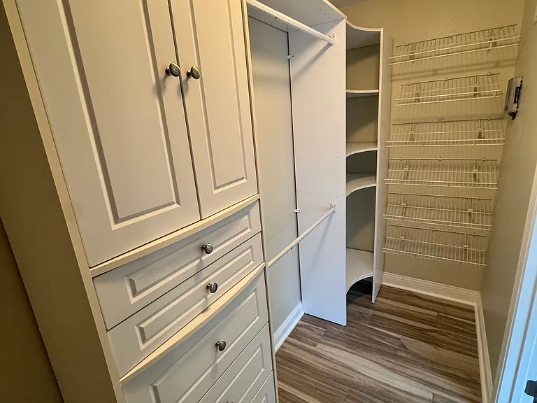 Master closet with custom built-in shelving.