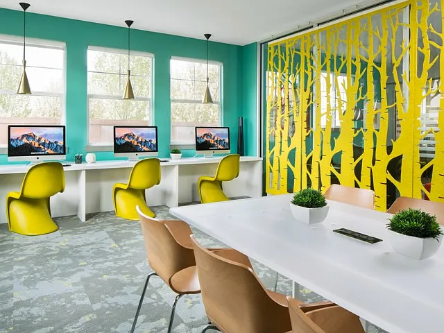 Avia Lowry's cyber lounge with Macbooks and a meeting space for residents to work from home.
