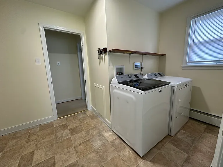 Laundry room with new washer and dryer.