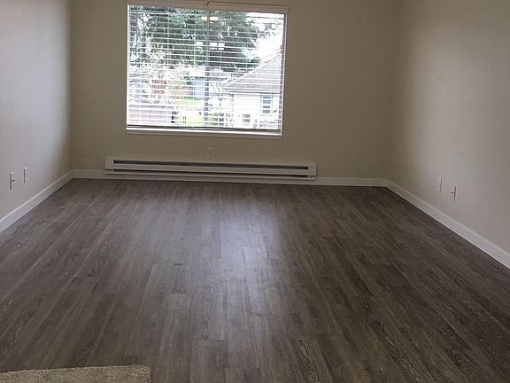 Livingroom with new vinyl plank flooring, new trim, paint, heater, light and blinds