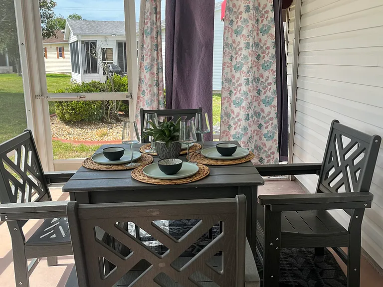 All weather dining set rear lanai. Curtains to block sun