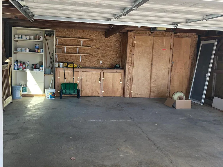 Garage with work bench and storage, remote door opener.