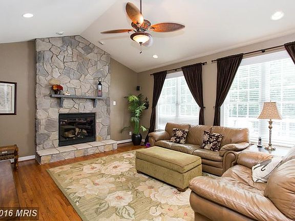 Cathedral ceilings, wood floors and ceiling fan.