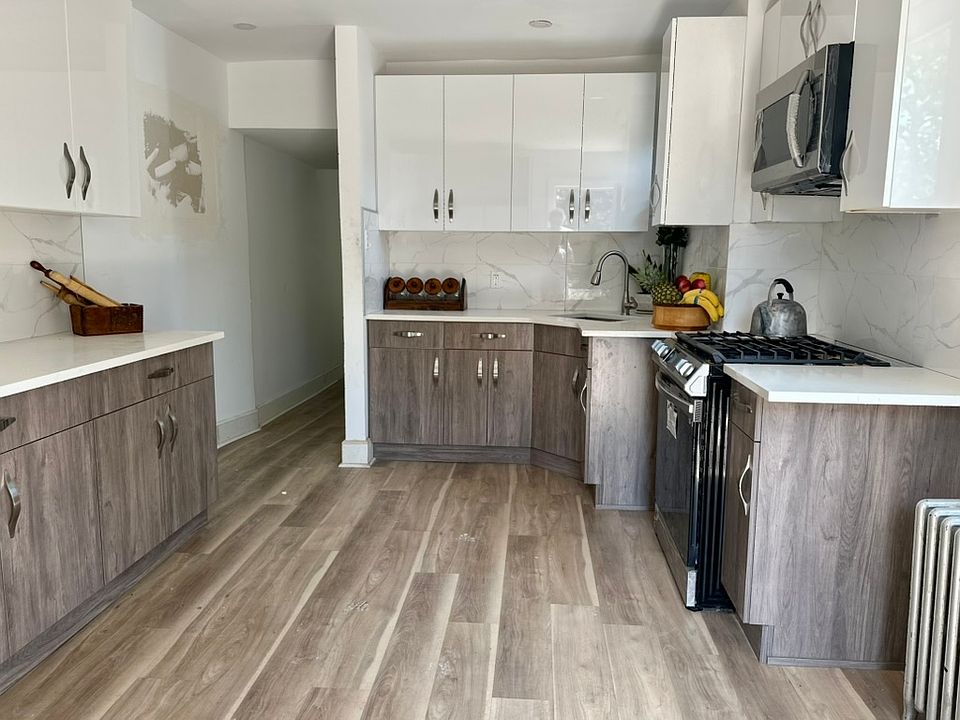 Freshly renovated kitchen, new stainless steel Samsung appliances, side by side refrigerator, new stove, new floors.